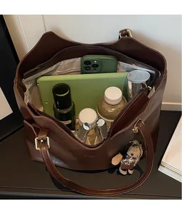Detail view of large brown tote bag interior showing spacious storage and inner pocket