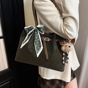 Olive green tote bag in matte leather with printed silk scarf and plush bear pendant