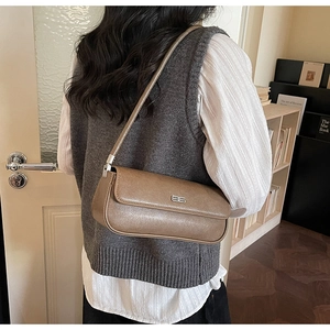 Retro brown baguette bag shown at a 45-degree angle on a model for daily commuting style