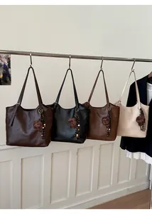 Detail of four retro PU leather tote bags in dark brown, black, brown and beige colors