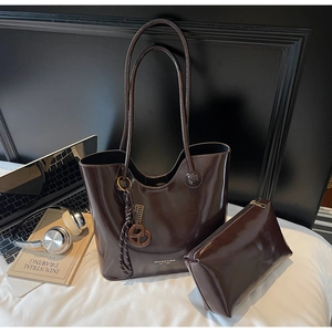Polished brown patent leather tote bag set with matching zipper pouch and accessories