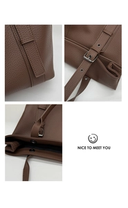 Detail of brown lychee grain leather tote bag showing silver metal buckle and stitching