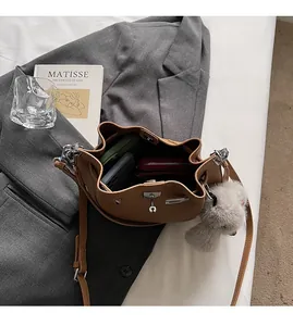 Interior view of brown leather bucket bag showing large capacity and magnetic closure