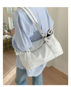 Minimalist white litchi pattern leather tote bag shown on shoulder in casual setting