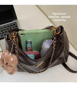 Spacious interior of dark brown dumpling bag with tablet and daily essentials