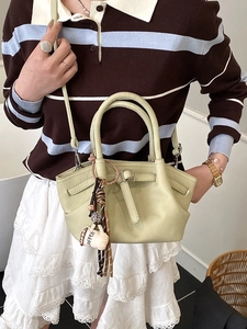 Fashionable light lime green bucket bag with lychee texture and coffee cup charm