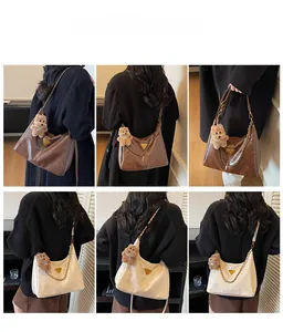 Detail view of large hobo tote bags with metal chain and plush bear charm decoration