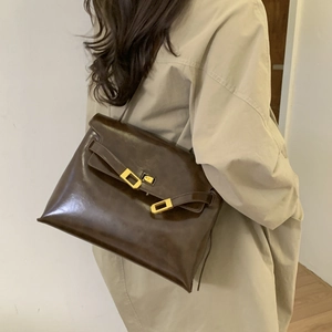 Classic dark brown glossy leather shoulder bag with gold metal buckle for daily commute