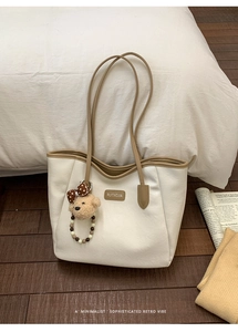 Vue détaillée du sac cabas rétro avec couture contrastée et charm ours en peluche