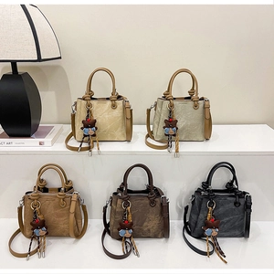 Detailed display of five colorful retro bucket bags with cute bear charms on steps