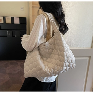 Detailed view of the puffy quilted shoulder bag showing large capacity and soft texture