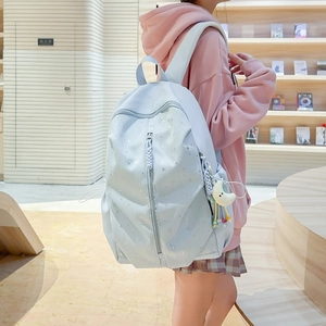 Detail of light blue star pattern backpack with star moon pendant and side pockets