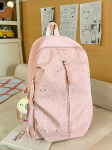 Pink minimalist school backpack with silver stars and moon pendant in a cozy room