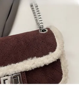 Detail of brown quilted suede texture with soft faux fur trim and silver metal twist lock