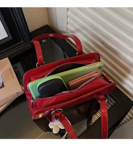 Interior view of a red glossy leather tote bag showing spacious capacity for daily items
