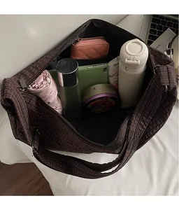 Spacious interior of brown checkered tote bag showing room for umbrella and tablet