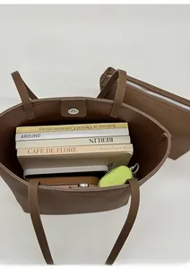Interior view showing large capacity of brown leather bucket bag with a small pouch
