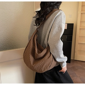 Brown checkered hobo bag shown in a cozy indoor setting for daily casual styling