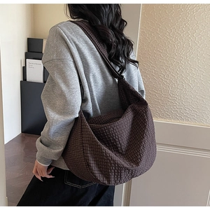 Detail of vintage brown checkered hobo bag showing large capacity and soft texture