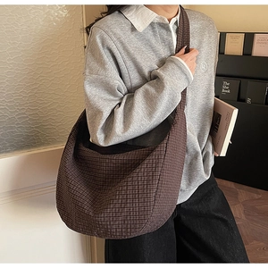 Detailed shot of a large brown checkered tote bag made of thick cotton canvas fabric