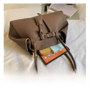 Deep brown tote bag with pebble leather texture showing large interior storage space