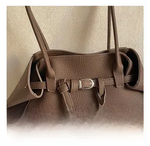 Detail shot of vintage dark brown tote bag with pebbled leather and silver buckle strap