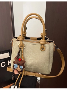 Vintage khaki canvas bucket bag with brown leather straps and cute bear pendant charm