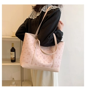 Detail of light pink tote bag with cartoon rabbit print and long shoulder straps