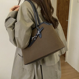 Brown textured wool tote bag with black leather shoulder strap and metal hardware