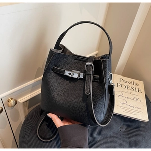 Close-up of black pebbled leather bucket bag featuring silver twist-lock and textured finish