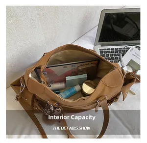 Spacious interior of brown leather tote bag showing storage for tablet and essentials