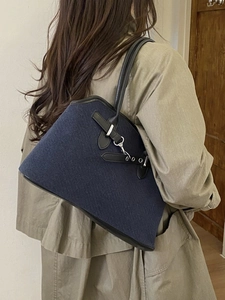 Retro dark blue denim tote bag with black leather trim and silver metal buckle detail