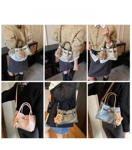 Detail view of stylish tote bags with metal turn-lock and cute plush bear charm