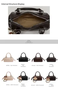 Detail view of cylinder shoulder bag interior and color range with bear pendant
