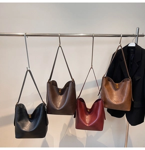 Detailed view of four large capacity PU leather tote bags in black, brown, and burgundy colors