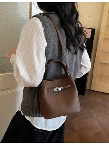 Brown lychee leather bucket bag with silver lock and adjustable shoulder strap