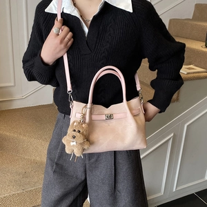 Detail of light pink matte tote bag featuring wave edge and cute plush bear charm