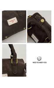 Detail of coffee brown faux leather bag showing stitching, brand label and gold buckle