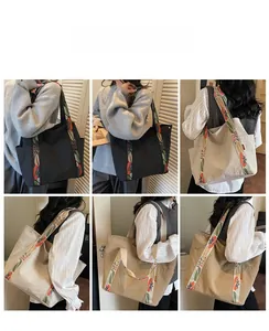 Detail of large tote bag showing side pockets and floral webbing straps in three colors