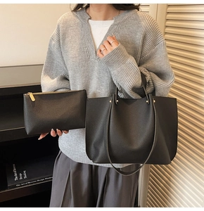Close-up of black lychee grain leather tote bag set including a matching zipper pouch