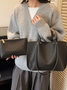 Fashionable black pebbled leather tote bag set with a matching small zipper pouch
