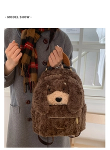 Detailed view of plush brown puppy backpack showing furry texture and brand logo tag