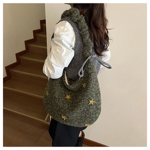 Dettaglio borsa tote in maglia verde muschio con ricamo a stella gialla