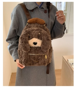 Detail of cute plush dog backpack featuring soft faux shearling texture and front zipper pocket