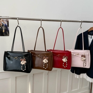 Detail view of large tote bags in four colors with glossy finish and cute dog charms
