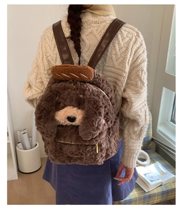 Detail of cute brown plush puppy backpack featuring leather straps and bread accessory