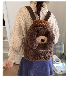 Detail view of plush puppy backpack showing curly faux fur and brown leather straps