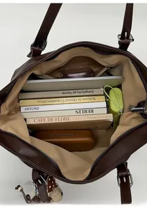 Interior view of large brown tote bag showing spacious capacity for books and tablet
