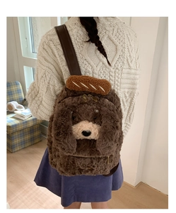 Detail of plush dog backpack with cute bread decor and adjustable brown leather straps
