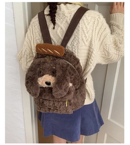 Detail of plush poodle backpack with 3D ears and brown faux leather straps